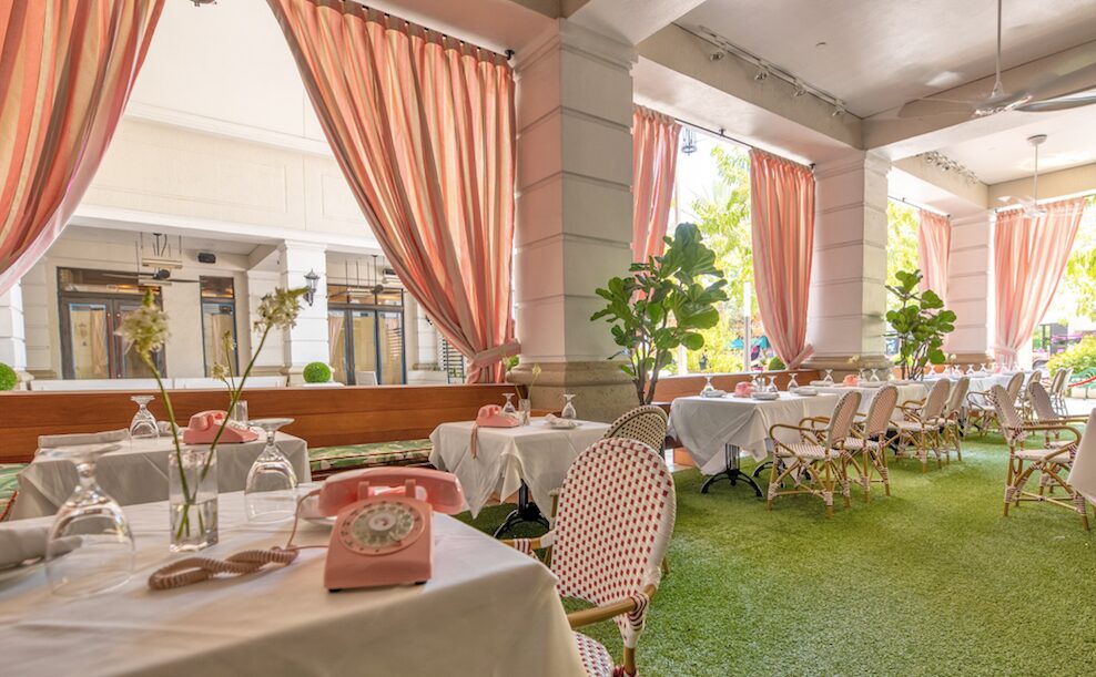 The Gramercy New Restaurant in Coral Gables outdoor dining with pink phones and curtains
